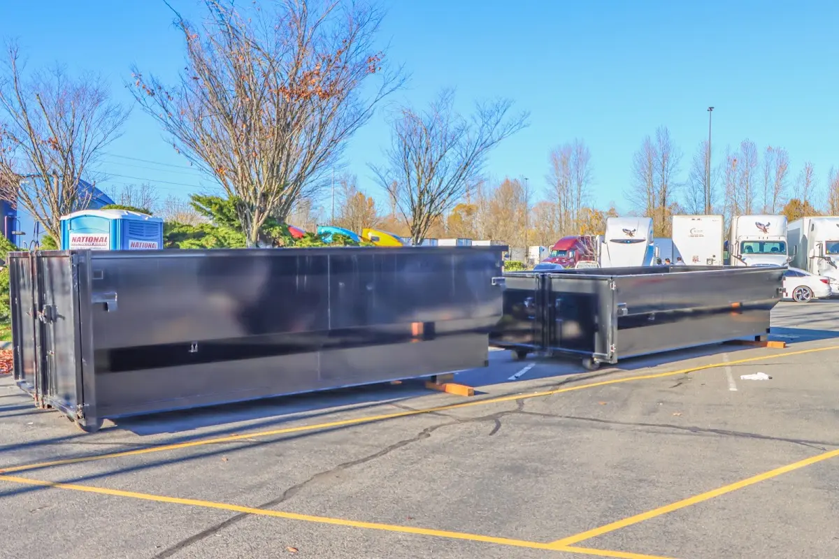 Professional dumpster rental service with roll-off container on residential driveway in Portsmouth